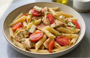 Nudelsalat mit Hähnchen: Saftige Tomaten, würziger Käse und einfaches Dressing Nudelsalat mit Hähnchen, Tomaten und Käse